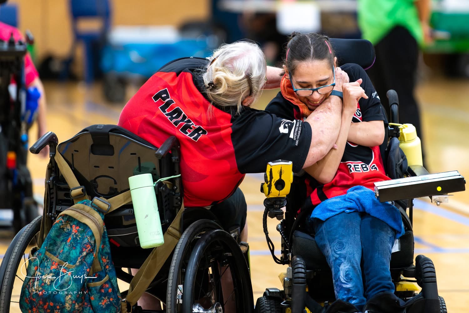 Two teammates sharing a hug on court