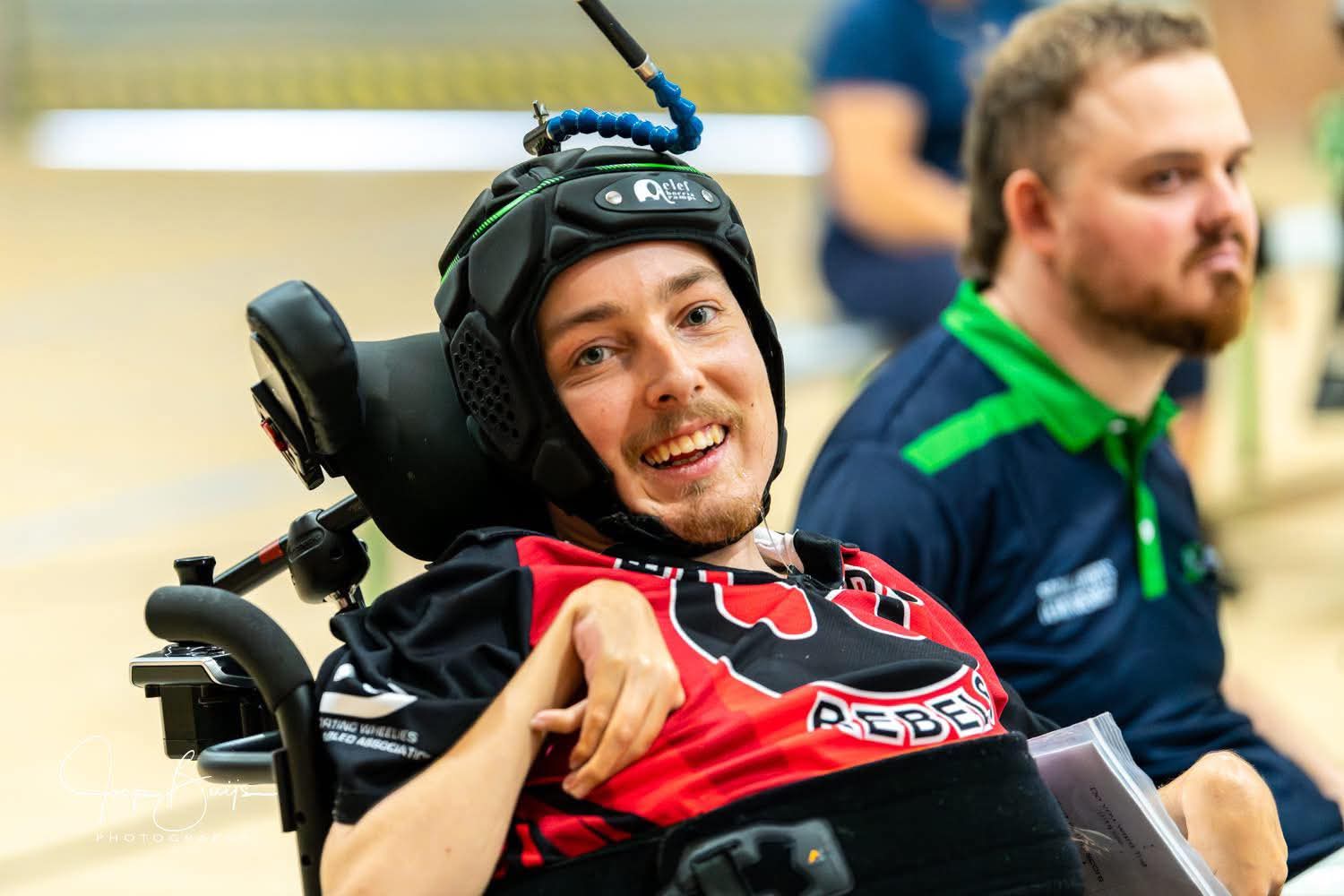 Smiling Rebels athlete wearing a pointer helmet